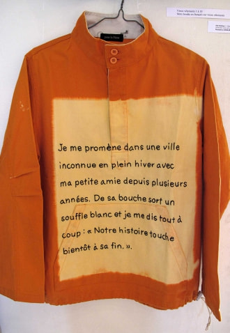 牛島光太郎の作品『old clothes』。漂白した古着に文字（言葉）を刺繍した作品。